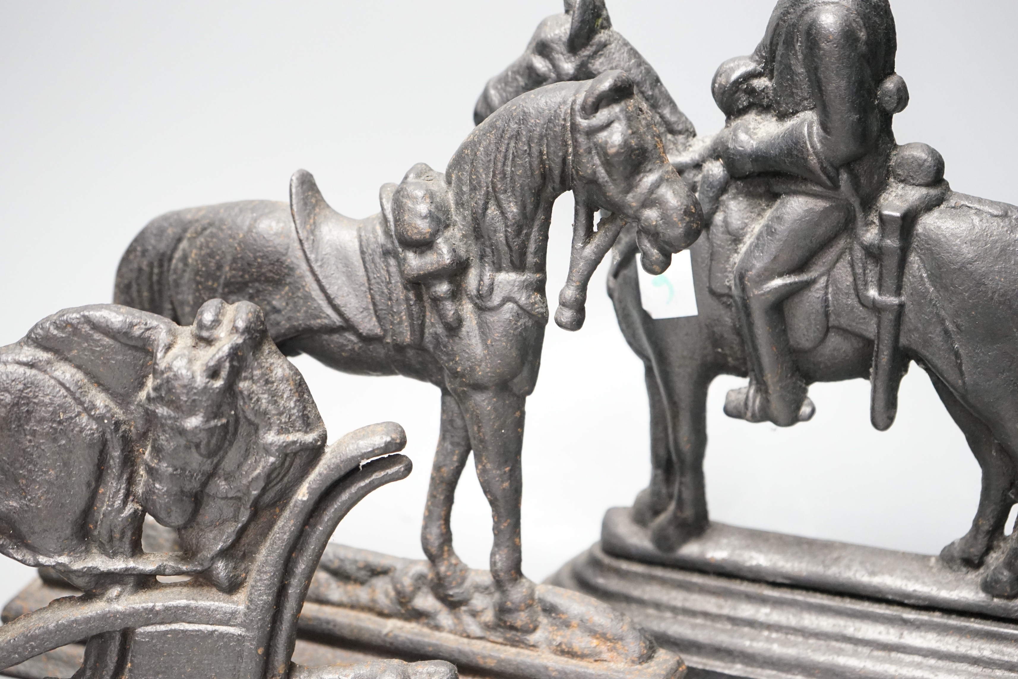 Four assorted cast iron horse door stops, tallest guardsman on horse back 28cms high